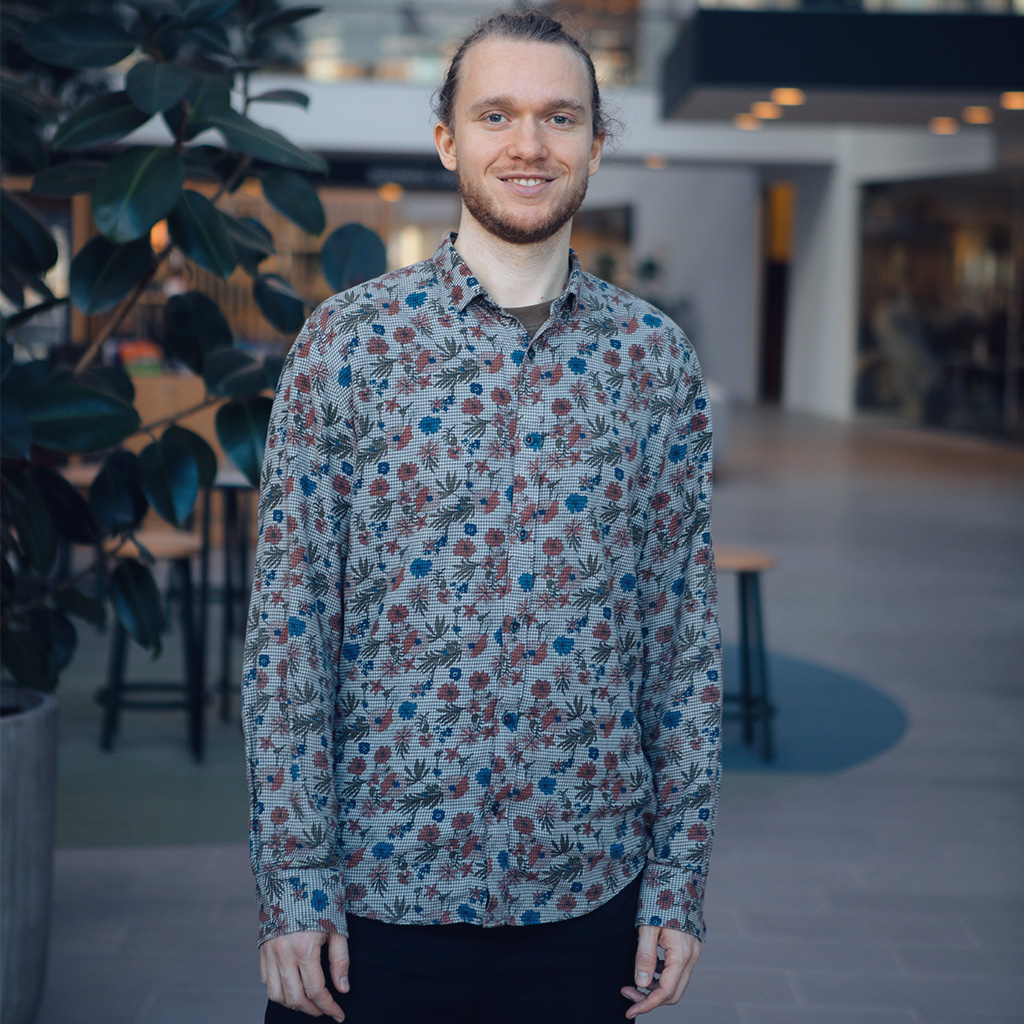 Image of Mads-Bjørn Hjelmar standing in an office lobby.